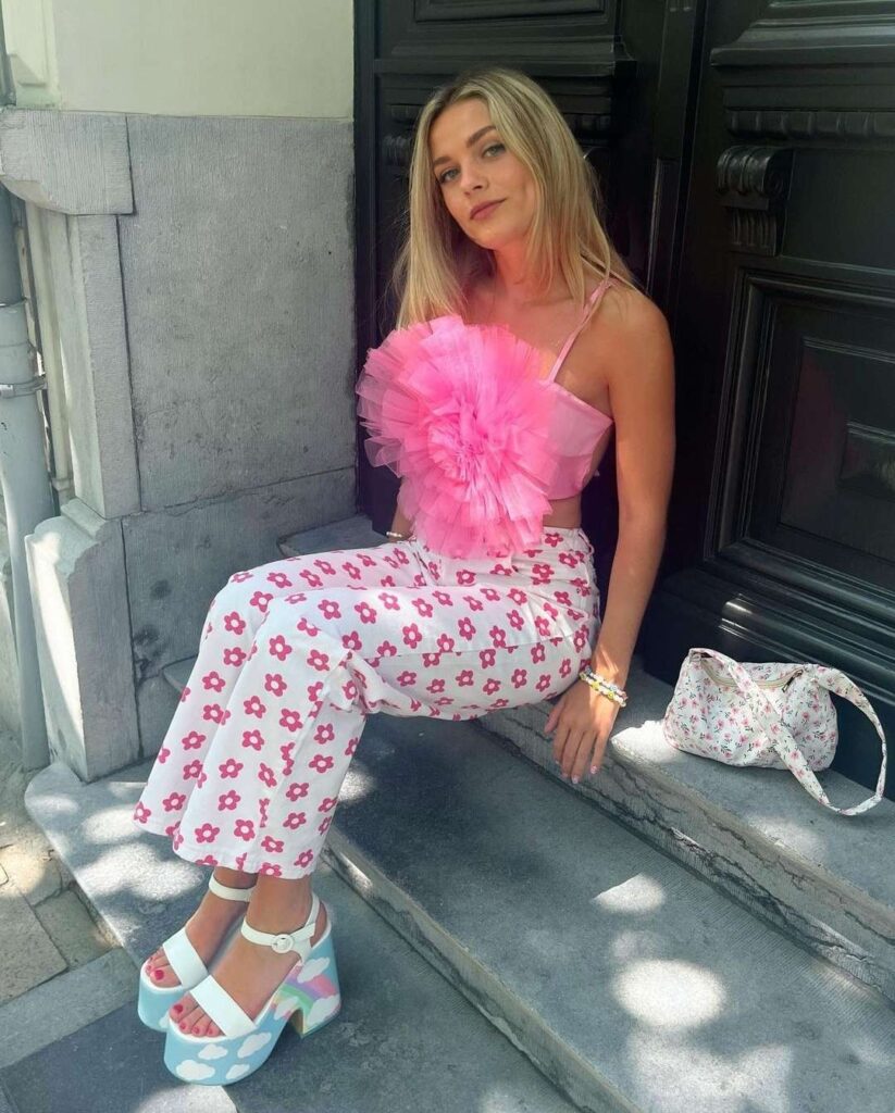 Lola wearing a pink flower tank top with white and pink flower trousers