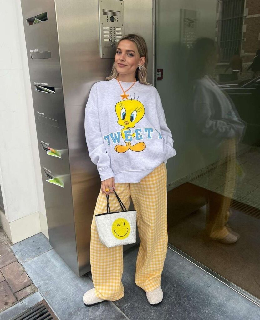 Lola wearing a tweety shirt with flannel trousers