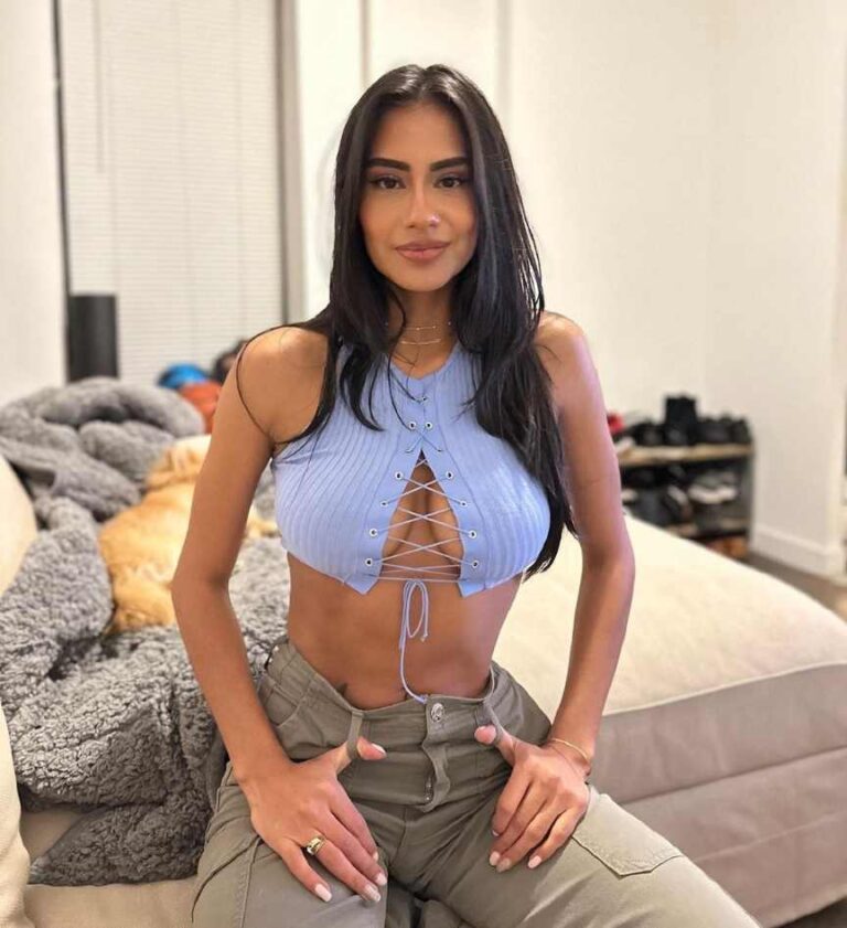 Jess wearing a sleeveless ribbed crop top with High-waisted beige cargo pants