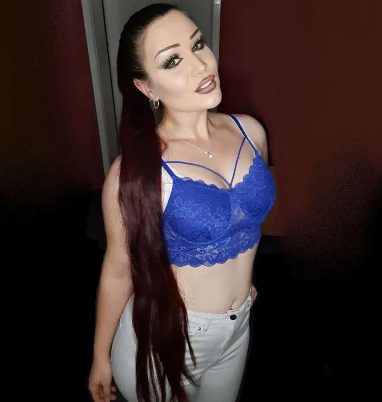 girl wearing a blue lace bralette with white high-waisted jeans