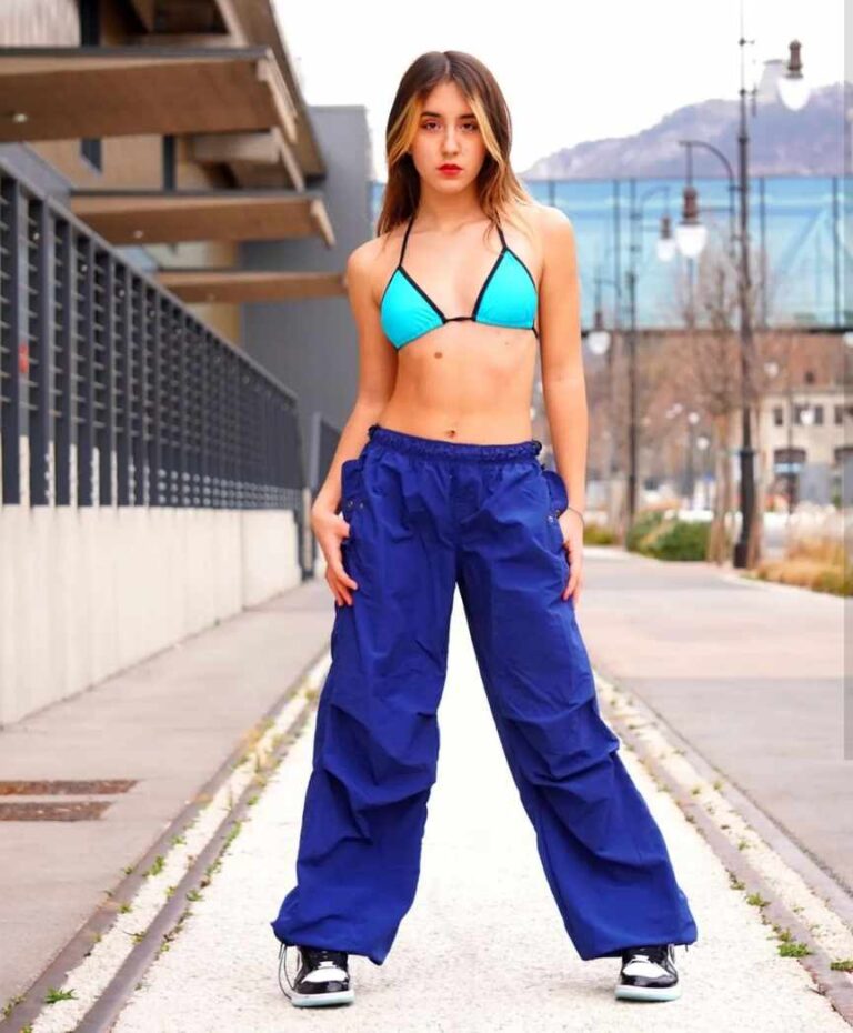 girl wearing a turquoise triangle bikini top and royal blue parachute pants