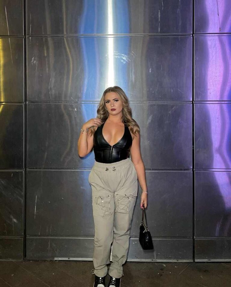 Girl wearing a black leather halter top with cargo pants