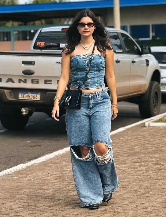 Kelly wearing a denim tube top with wide leg distressed jeans