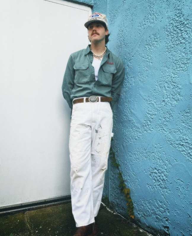 Crust wearing a light green vintage button-down with white jeans