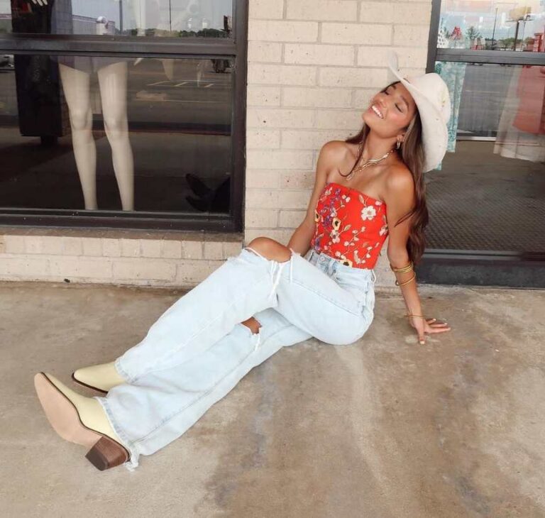 Girl wearing A red floral tube top with ripped jeans