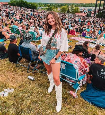 Josie wearing denim skirt paired with breezy white tee