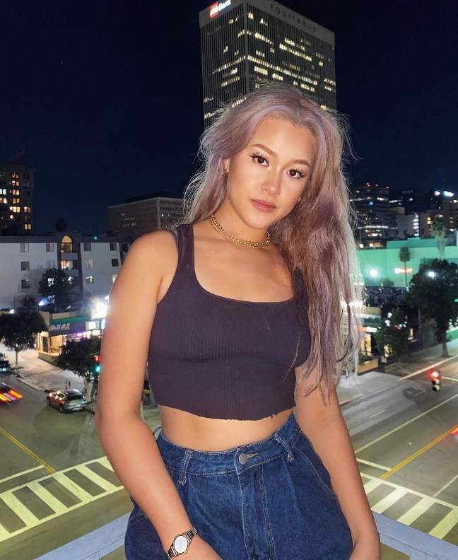 Sophia wearing a deep charcoal ribbed crop top with dark denim jeans