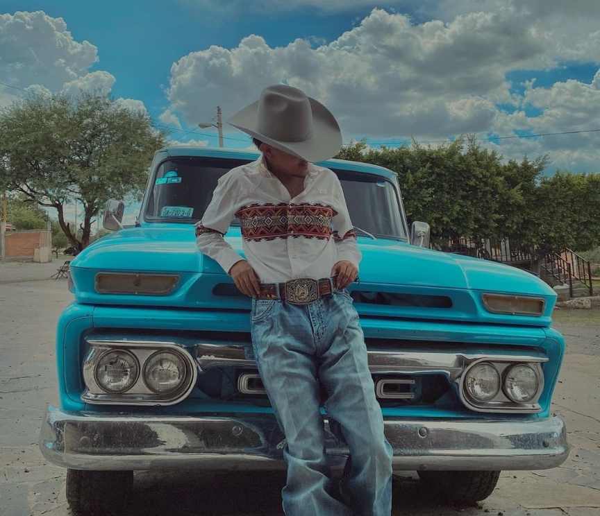 Ulises wearing a white long-sleeve shirt with classic blue jeans