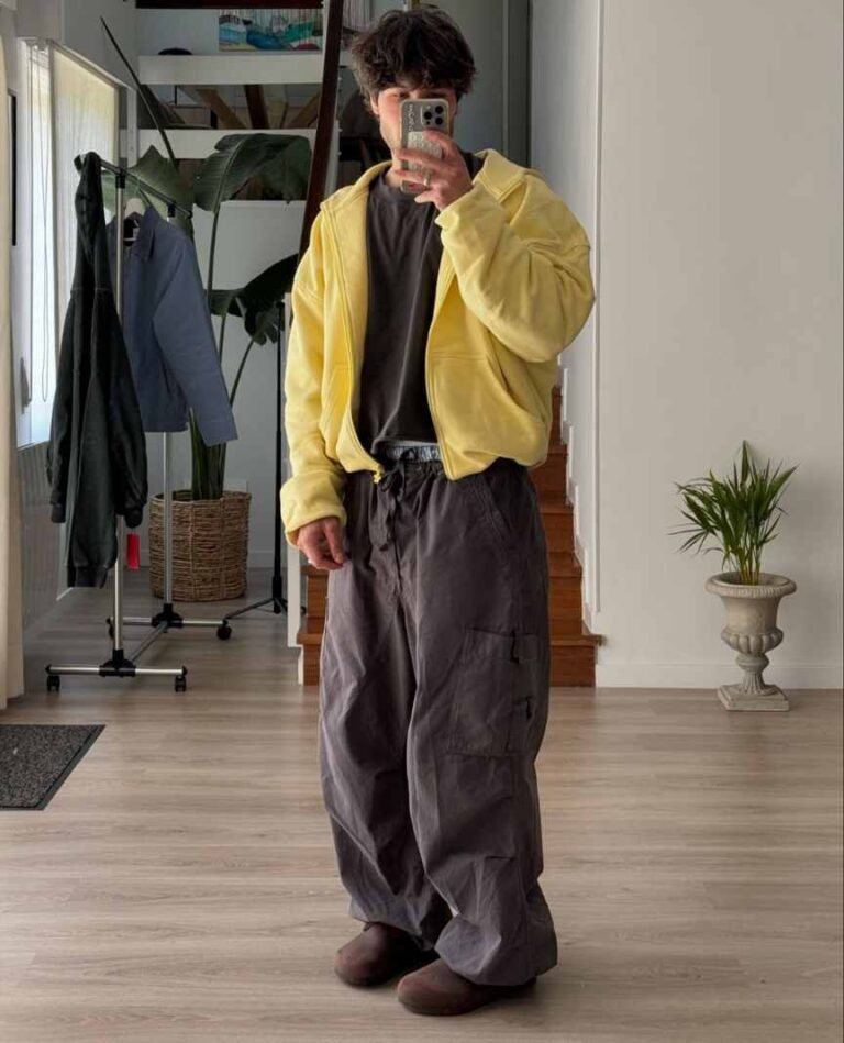 aader wearing a yellow zip up hoodie over a charcoal grey t-shirt with loose fitting cargo pants