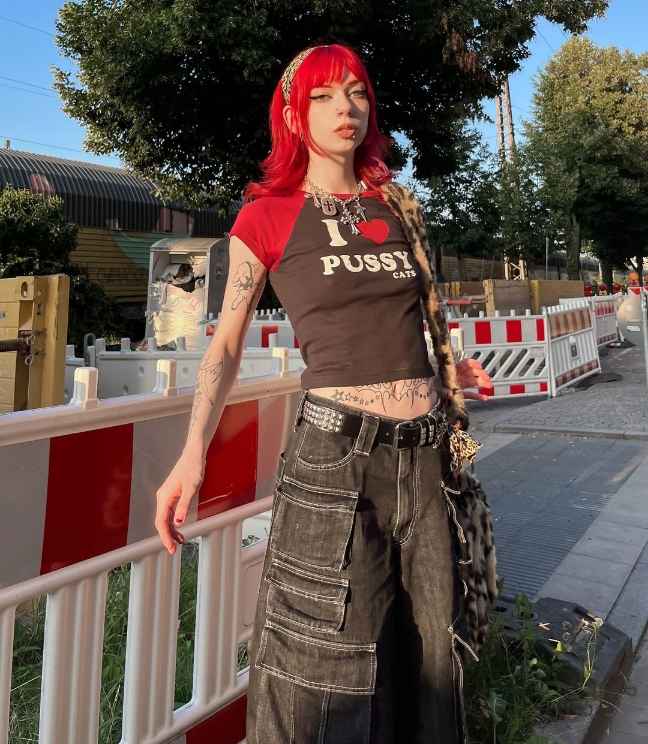 alicia wearing a cropped black graphic t-shirt with wide leg jeans