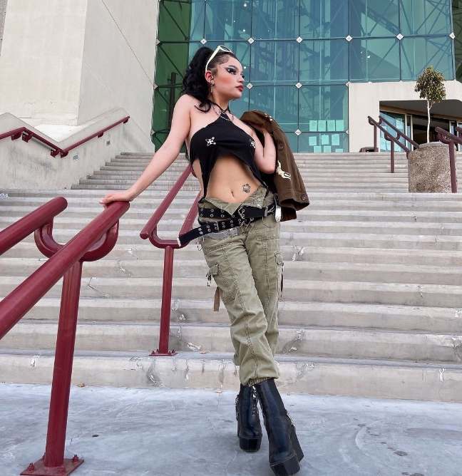 angeline wearing a black crop top with cutouts with olive green cargo pants