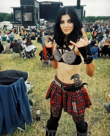 girl wearing A studded bralette paired with a red plaid skirt