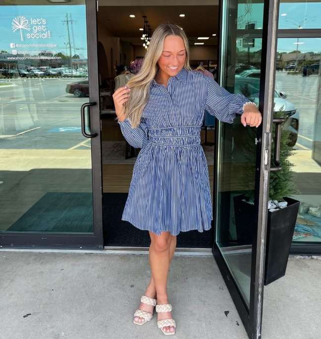 girl wearing a blue and white striped shirt dress