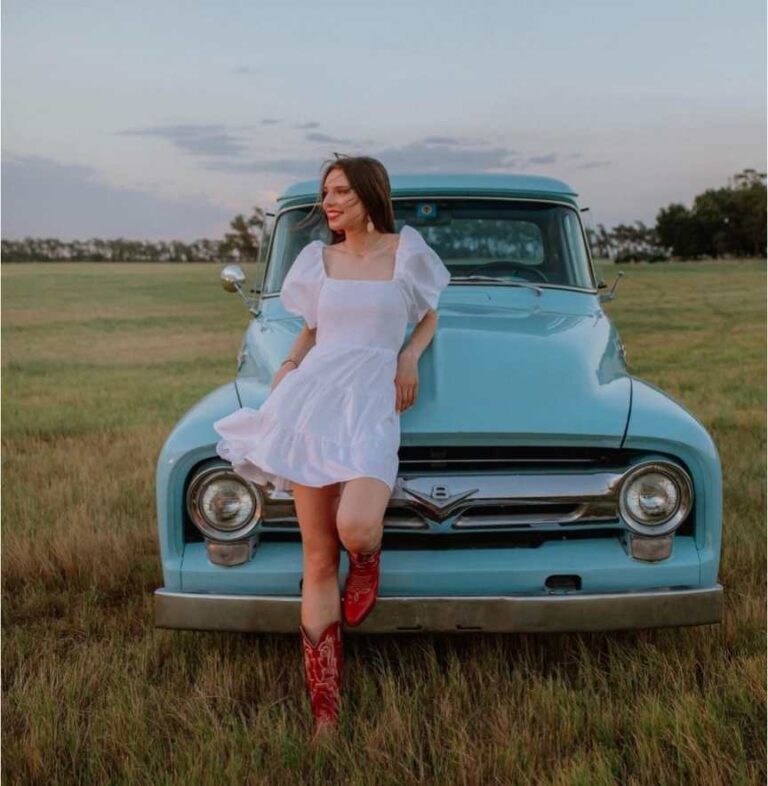 girl wearing a flowing white dress with puffed sleeves