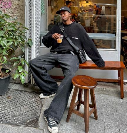 guy wearing a black oversized sweater with black wide-leg jeans