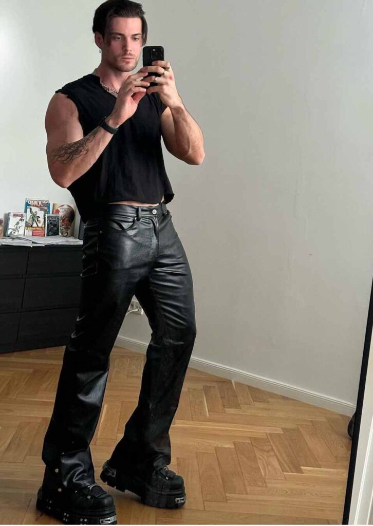 guy wearing a sleeveless black tank top with black leather pants