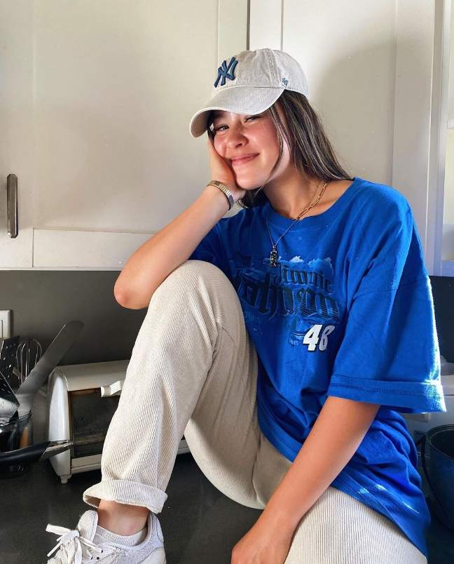 sophia wearing a oversized blue graphic t-shirt with Cream, ribbed, corduroy-like trousers