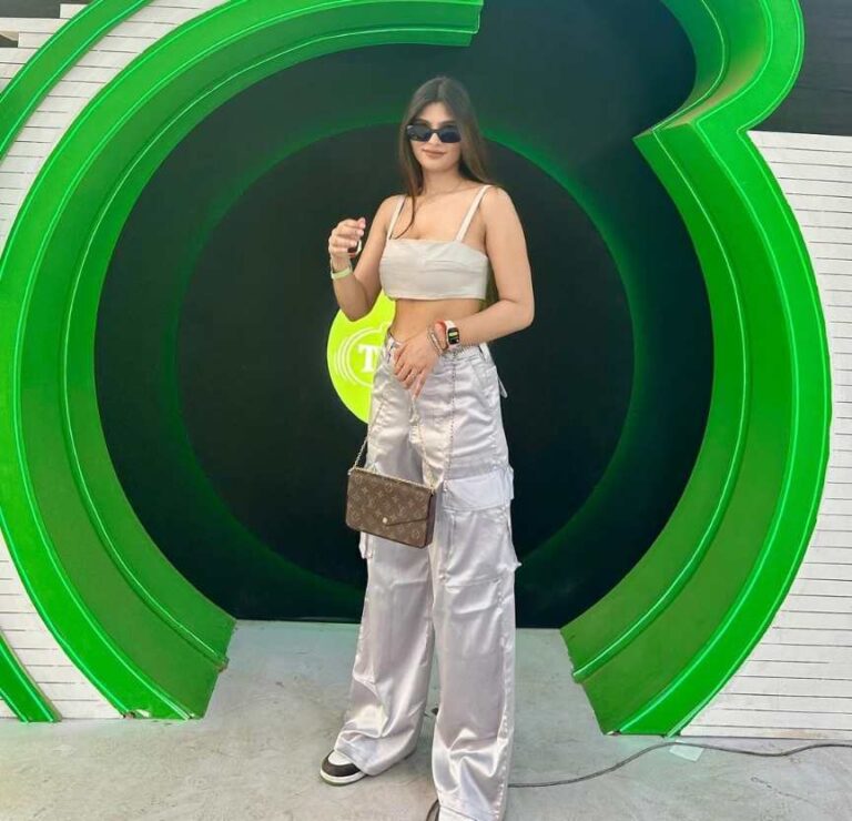 amrita wearing white spaghetti-strap crop top paired with shiny silver cargo pants