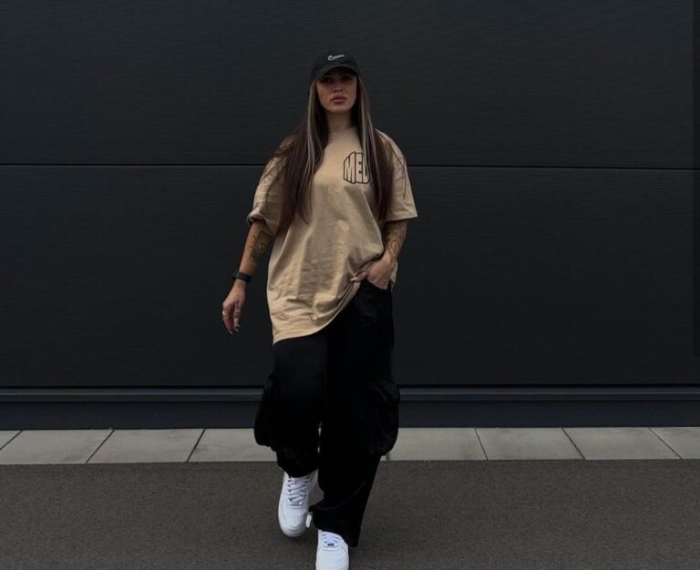 carina wearing oversized beige tee with baggy black cargo pants