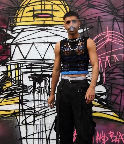 guy wearing A black mesh sleeveless crop top with black cargo pants