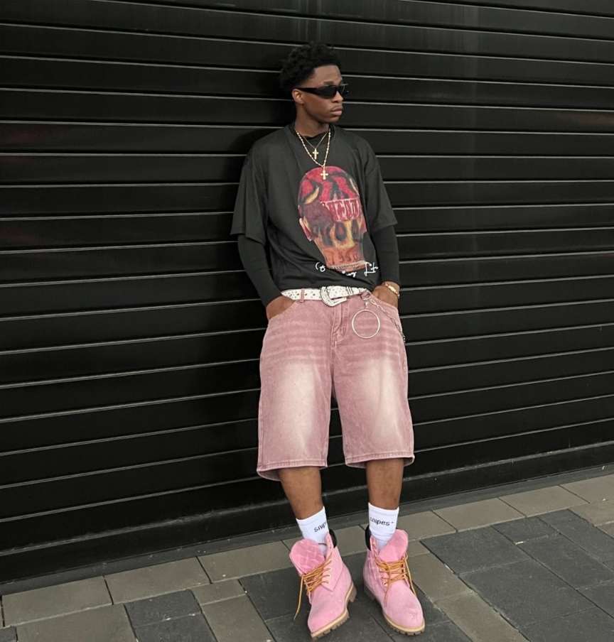 jekhiel wearing a bold black graphic long-sleeve tee with pink, washed-out shorts