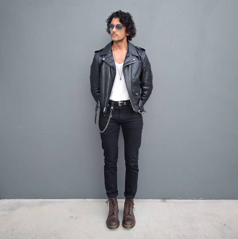 kittu wearing a black leather jacket, a white tank top, and slim black pants