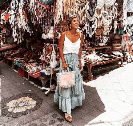 lisa wearing A white tank top paired with a flowy, tiered maxi skirt