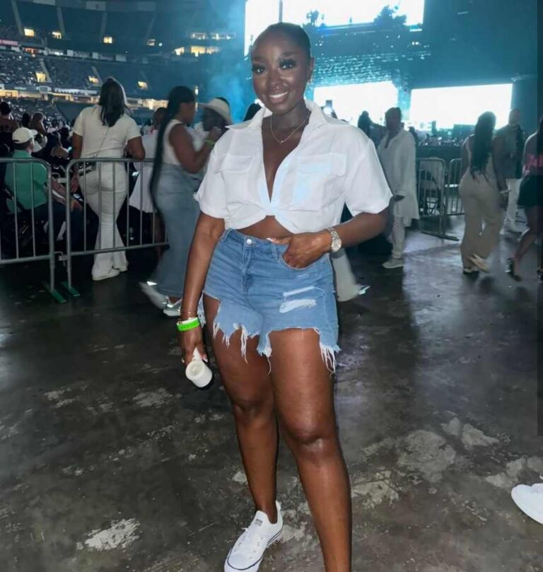 mena wearing white cropped button-up shirt paired with distressed denim shorts