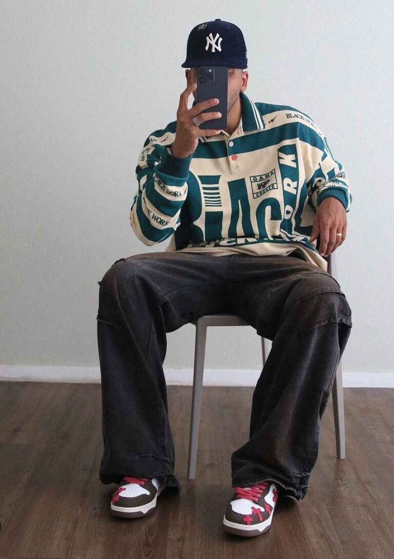 sergio wearing a vintage rugby shirt with some baggy dark-wash jeans