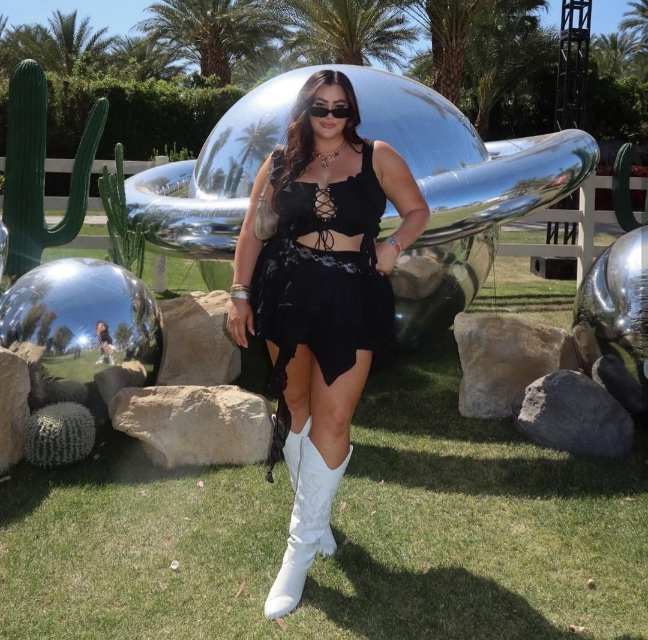 vanessa wearing A black lace-up crop top paired with a black mini skirt