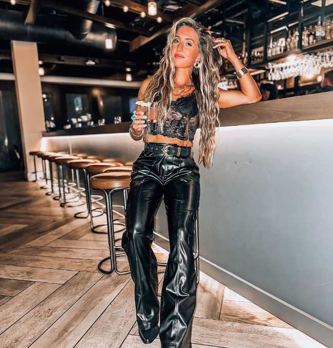 elizabeth wearing A black lace bralette top with sleek black leather pants