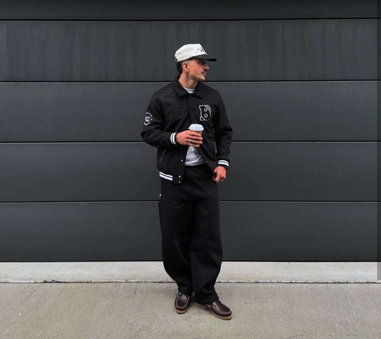 joao wearing A black varsity jacket with wide-leg pants and a crisp white tee