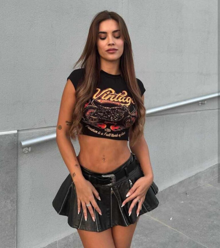 monica wearing a black crop top with a black leather skirt