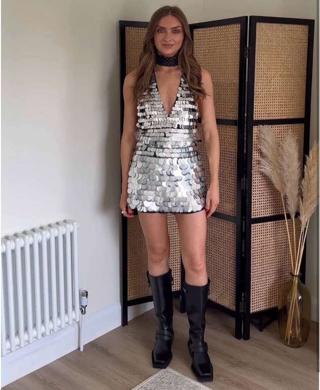 girl wearing a silver sequined halter-style mini dress with a deep V-neckline