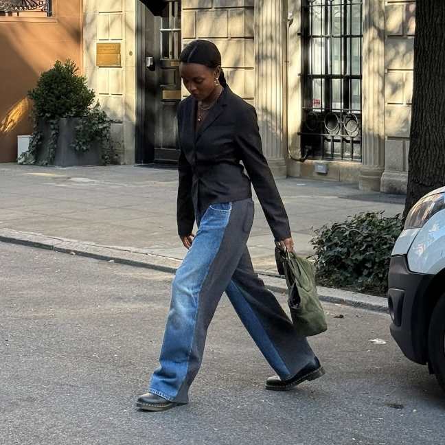 girl wearing a tailored black blazer paired with two-tone wide-leg jeans and doc martens