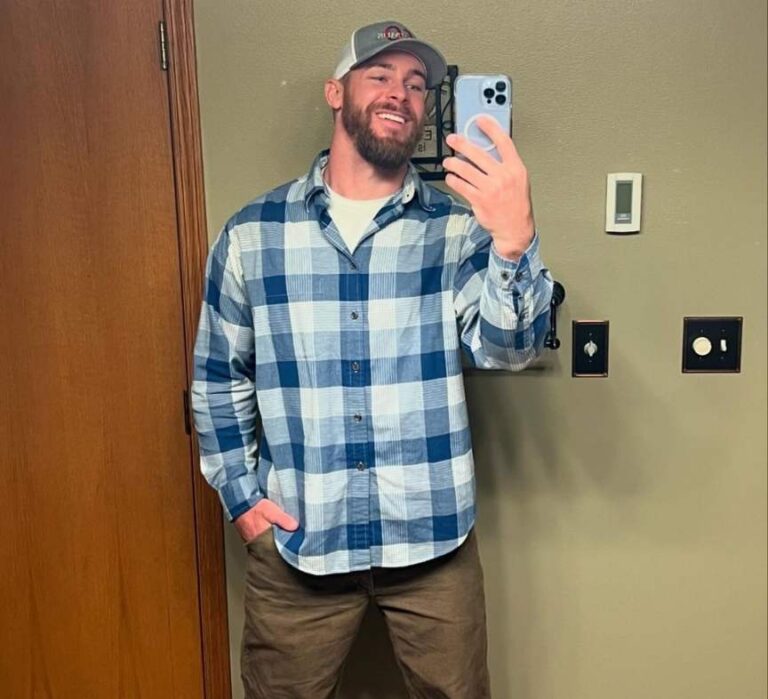 guy wearing A navy and white plaid oversized flannel layered over a fitted white long-sleeve thermal shirt with Slim-fit brown cargo joggers