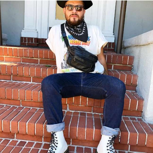 guy wearing white Doc Martens and cuffed dark denim with white tee