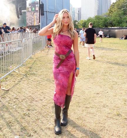 katie wearing a strapless pink maxi dress with a marbled pattern and a high side slit