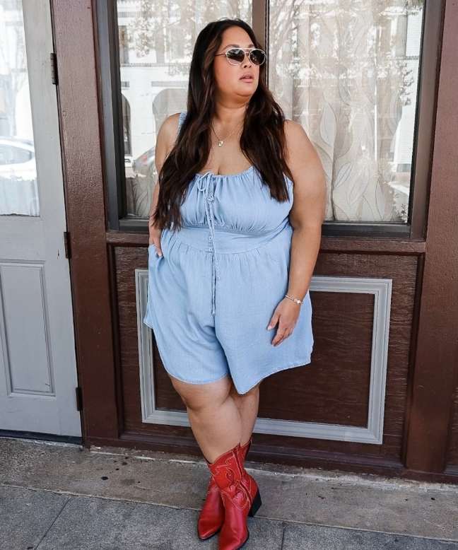 plus size girl wearing a light blue romper