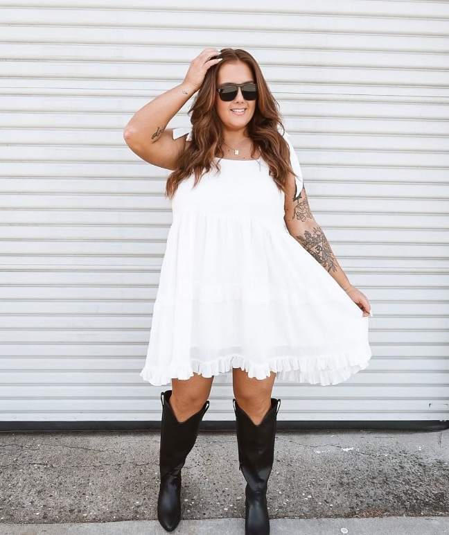 plus size girl wearing a white sleeveless tiered mini dress